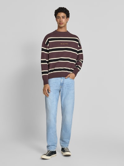 Männermodel trägt Regular Fit Jeans im Used-Look Modell 'CLARK' von Jack & Jones aus reiner Baumwolle, Eingrifftaschen, Ganzkörperansicht von vorne.