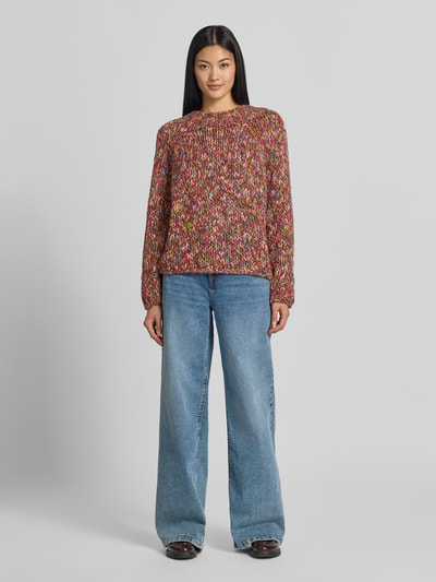 Vrouwenmodel draagt Regular Fit pullover met schurwoll-aandeel in tricotlook van Rich & Royal, bont gekleurd, elastische materiaalmix, ronde hals, ruglengte maat S 60 cm, mouwlengte maat S 67 cm, trui in gebreide textuur, voorkant volledig zichtbaar, geheellichaamsaanzicht van voren.