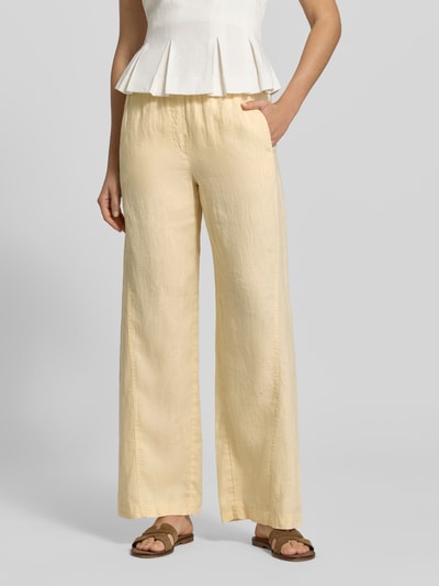 Frauenmodel trägt Leinenhose mit elastischem Bund Modell 'Mileni resort' von OPUS, Wide-Leg-Pants aus Reine Leinen, französische Eingrifftaschen, Gesäßtaschen, Kordelzug, Farbe Creme, Ganzkörperansicht von vorne.