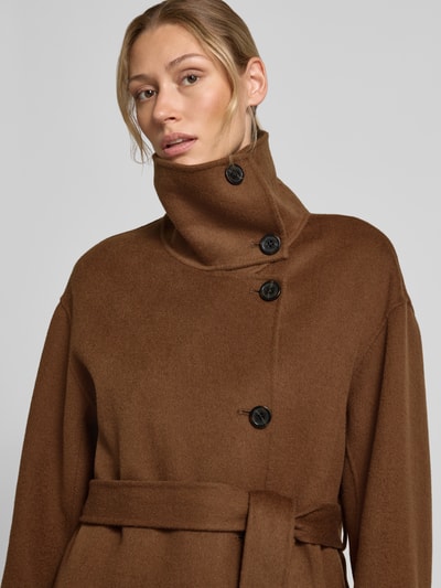 Frauenmodel trägt Mantel aus Woll-Mix mit Stehkragen Modell 'PANAME' von OAKWOOD in Braun, glatte Textur, Nahaufnahme Oberkörper.
