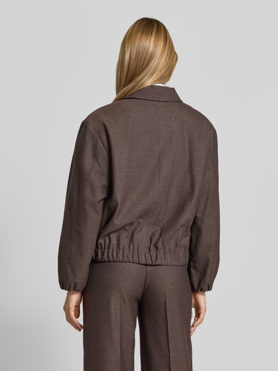 Frauenmodel trägt Regular Fit Blazer mit Reißverschluss von MORE & MORE in Braun, Umlegekragen, glatte Textur, Ganzkörperansicht Rückansicht.