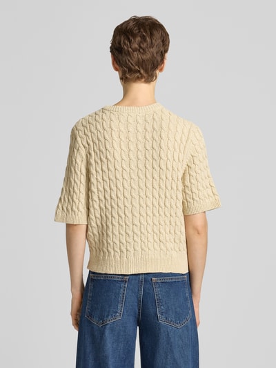 Männermodel trägt kardigan z mieszanki bawełny i lnu model 'Diva' od My Essential Wardrobe, ścieg warkoczowy, krój regular fit, okrągły dekolt, listwa guzikowa, rękaw o dł. 1/2, kremowy, długość tyłu w rozmiarze S: 50 cm, długość rękawów w rozmiarze S: 28 cm, widok całej sylwetki z tyłu