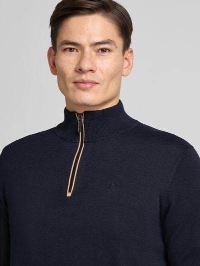 Männermodel trägt Strickpullover mit Stehkragen von Bugatti in Dunkelblau, Reine Baumwolle, Regular-Fit, gerippte Abschlüsse, Nahaufnahme Oberkörper.
