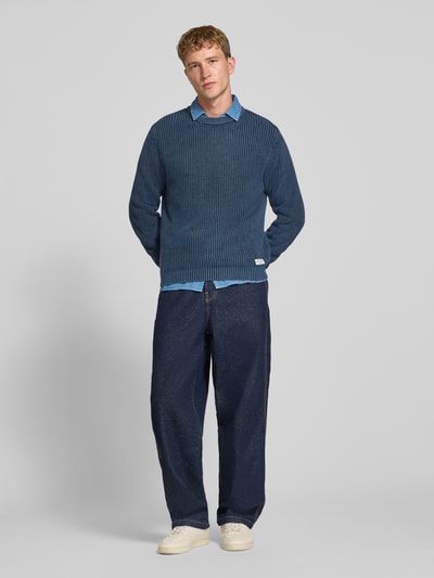 Männermodel trägt Regular Fit Pullover aus reiner Baumwolle Modell 'DORIAN CREW' von Pepe Jeans in Blau, Herren Pullover, Ganzkörperansicht von vorne.
