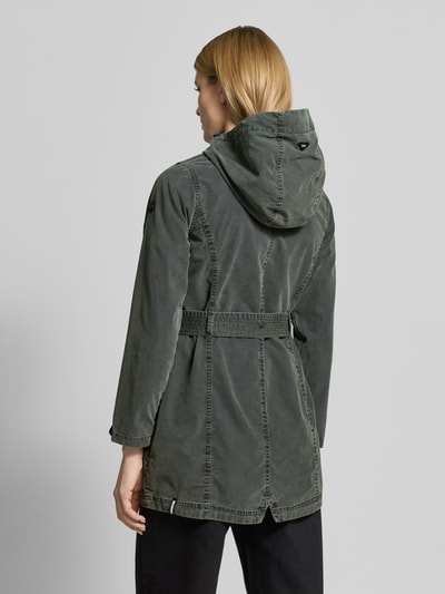 Frauenmodel trägt Jacke mit Bindegürtel Modell 'PREA' von khujo in Dunkelgrün aus Baumwoll-Mix, Rückenlänge 37 cm, Ganzkörperansicht Rückansicht.