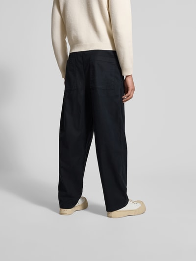 Männermodel trägt Loose Fit Stoffhose mit Lyocell-Anteil von Officine Générale, schwarz, Baumwoll-Lyocell-Mix, Rückansicht Ganzkörperansicht.