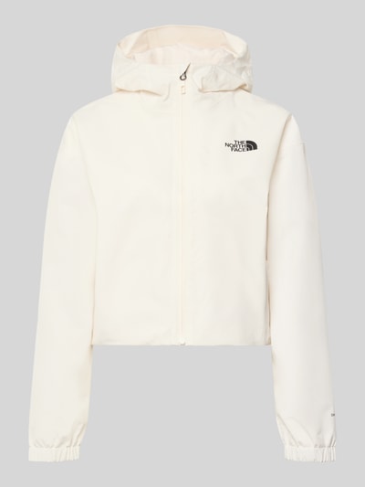 Produktfoto, Cropped Jacke mit Logo und Reißverschluss von The North Face, biała, gładka tkanina, kaptur, logo, zamek, długość tyłu w rozmiarze S: 58 cm, szerokość ramion w rozmiarze S: 54 cm, szerokość klatki piersiowej w rozmiarze S: 50 cm, długość rękawa w rozmiarze S: 56 cm