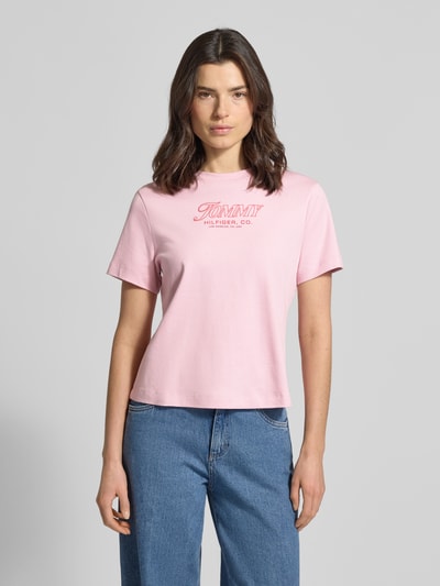 Frauenmodel trägt Slim Fit T-Shirt aus reiner Baumwolle von Tommy Hilfiger, Optik: Unifarben, Label-Print, Rundhals, Jersey, Kurzarm, Ganzkörperansicht von vorne.