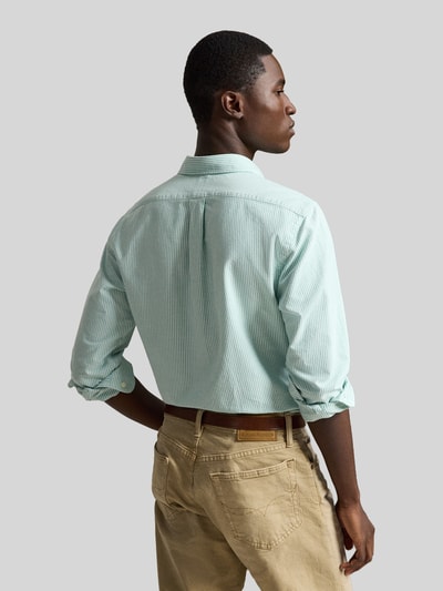 Männermodel trägt Custom Fit Freizeithemd aus reiner Baumwolle von Polo Ralph Lauren in Hellgrün mit feinen Streifen, Ganzkörperansicht Rückansicht.
