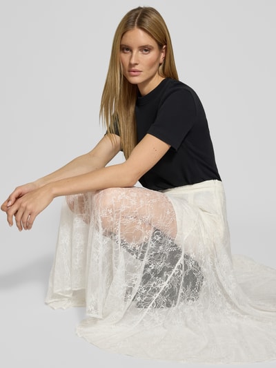Frauenmodel trägt Spitzenrock in A-Linie Modell 'LEA' von Copenhagen Muse, weiß, zarte Spitze, elegante Textur, Nahaufnahme Oberkörper.