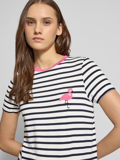 Frauenmodel trägt Regular Fit T-Shirt aus Viskose-Mix Modell 'HEART LIFE' von Only, Allover-Streifenmuster, Stickapplikation Flamingo, Kontrastdetail am Rundhalsausschnitt, Nahaufnahme Oberkörper.