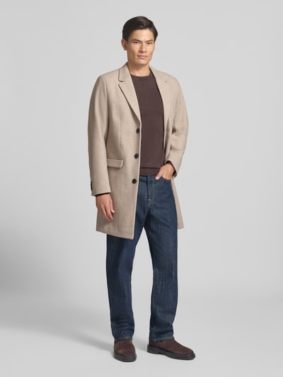 Männermodel trägt Mantel mit Reverskragen und Pattentaschen von Lindbergh in Beige, Slim Fit, Knopfleiste, Ganzkörperansicht von vorne. Kontext: Damen Mantel von Lindbergh, Reverskragen, Knopfleiste, Pattentaschen, Rückenlänge bei Größe M 102 cm, Schulterbreite 40 cm, Brustweite 51 cm, Ärmellänge 65 cm.