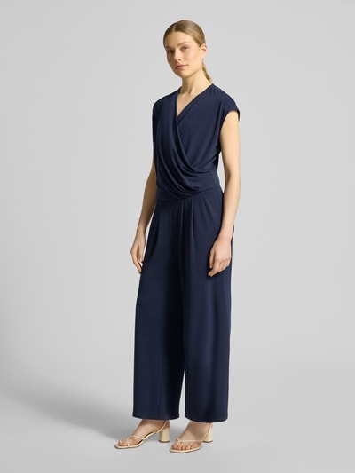Vrouwenmodel draagt Jumpsuit in Wickel-Optik mit V-Ausschnitt van ROBE LÉGÈRE, donkerblauw, materiaalmix met stretch, regular fit, wikkellook, V-hals, ruglengte maat 36: 49 cm, borstwijdte maat 36: 42 cm, totale lengte maat 36: 147 cm, binnenbeenlengte maat 36: 63 cm, geheelbeeld van voren