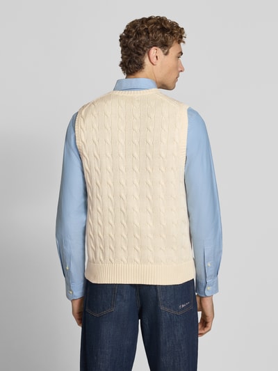 Männermodel trägt Regular Fit Pullunder aus reiner Baumwolle von Polo Ralph Lauren in Beige mit Zopfmuster, Ganzkörperansicht Rückansicht. Herren Pullunder von Polo Ralph Lauren.
