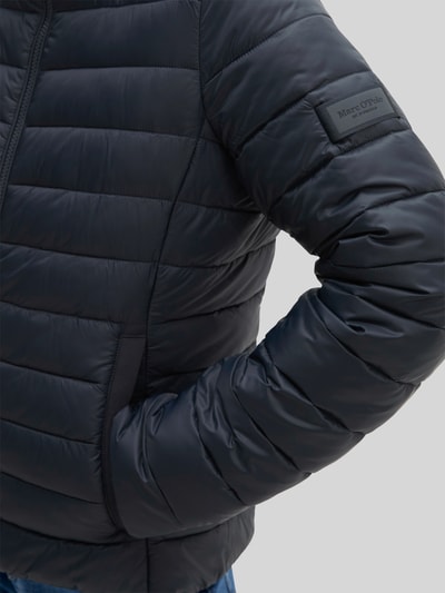 Vrouwenmodel draagt Regular Fit gewatteerd jack met opstaande kraag van Marc O'Polo in donkergroen met horizontale naden, detailopname, Dames Steppjacke von Marc O'Polo.