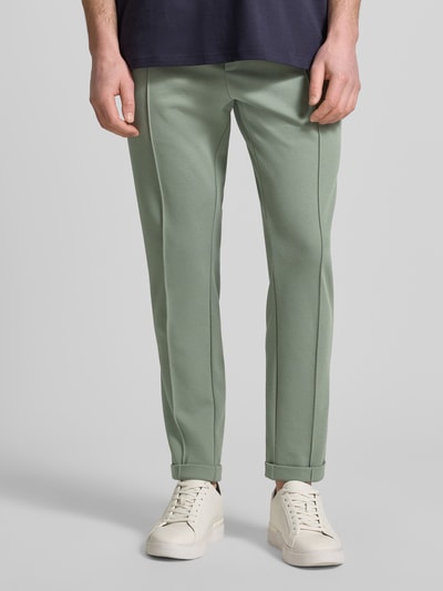 Męski model nosi Regular Fit Hose mit elastischem Bund von Antony Morato, mieszanka bawełny, krój regular fit, zielone spodnie z szwami pionowymi, elastyczny pas, szerokość w rozmiarze M: 41 cm, długość wewnętrzna nogawki: 76 cm, zdjęcie całych nóg z przodu.