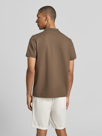 Männermodel trägt Regular Fit Poloshirt mit Strukturmuster von MCNEAL in Braun, Kurzärmelig, Baumwoll-Mix, Reißverschluss, Ganzkörperansicht Rückansicht.