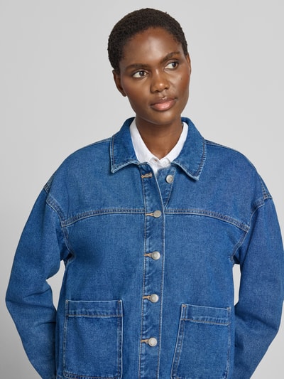 Vrouwenmodel draagt Oversized Langarmshirt uit katoenmix model 'JAMIE' van VERO MODA in blauw, grove textuur, Nahaufnahme bovenlichaam.