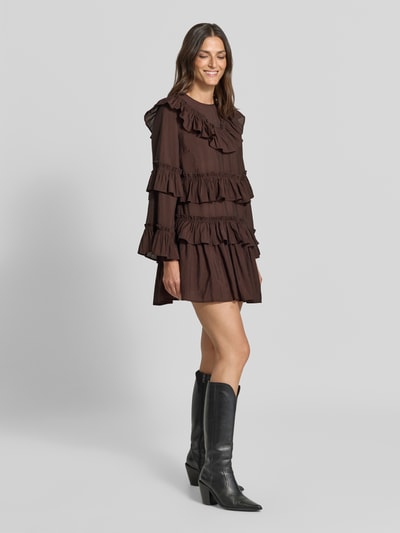 Frauenmodel trägt Minikleid aus Viskose-Mix Modell 'RIMONE' von YAS in Braun, A-Linie, Volants, Rundhalsausschnitt, Ganzkörperansicht von vorne.