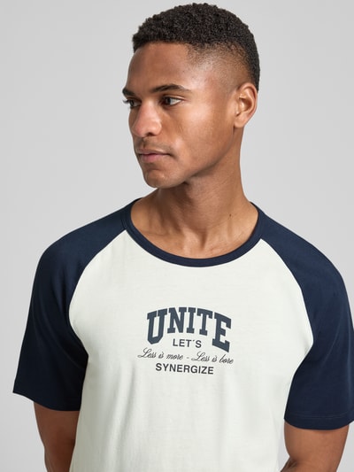 Männermodel trägt Regular Fit T-Shirt aus reiner Baumwolle von s.Oliver RED LABEL, Two Tone Design, Statement Print, Nahaufnahme Oberkörper.