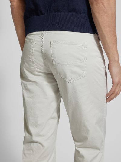 Männermodel trägt Regular Fit Stoffhose mit Lyocell-Anteil Modell 'Cadiz' von Brax in Beige, Detailaufnahme Rückansicht. Elastischer Baumwoll-Mix, 5-Pocket-Design.