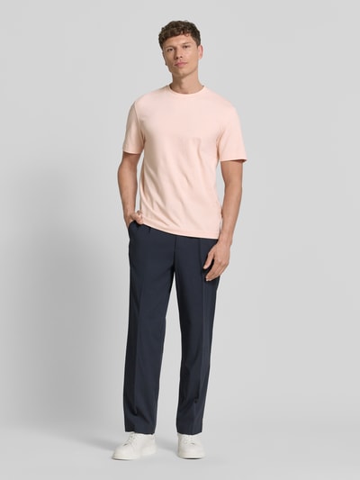 Männermodel trägt Relaxed Fit T-Shirt aus Baumwoll-Mix Modell 'TCHUP' von BOSS Orange, unifarben, Rundhals, Label Print, Jersey, Ganzkörperansicht von vorne.