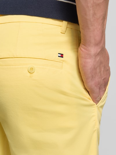 Mężczyzna nosi Regular Fit Bermudas aus Baumwoll-Mix od Tommy Hilfiger, kolor jednolity, logo, kieszenie, materiał bawełniany, detal tylu, zbliżenie tyłu.