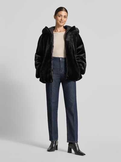 Frauenmodel trägt Kunstfelljacke mit Kapuze von Emporio Armani in Schwarz, samtige Textur, kombiniert mit Jeans und Boots, Ganzkörperansicht von vorne. Damen Kunstfelljacke gerade Passform, Kapuze, Reißverschluss, Raglanärmel, seitliche Eingrifftaschen, Maße für Größe 36: Rückenlänge 69 cm, Schulterbreite 46 cm, Brustweite 43 cm, Ärmellänge 60 cm.