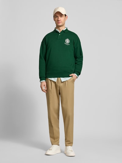 Männermodel trägt Regular Fit Sweatshirt aus Baumwoll-Mix von Polo Ralph Lauren, Optik: Unifarben, Label-Print, Polokragen, Langarm, Bündchen: Gerippt, Materialverarbeitung: Sweat, Ganzkörperansicht von vorne.