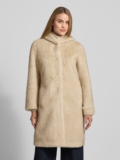Modelka kobieca nosi Wendemantel mit Kapuze und Eingrifftaschen od PETITE M., beżowy sztuczny futrzany płaszcz, regular fit, widok całej sylwetki z przodu. Długość tyłu 95 cm, szerokość ramion 41 cm, szerokość biustu 50 cm, długość rękawa 62 cm.