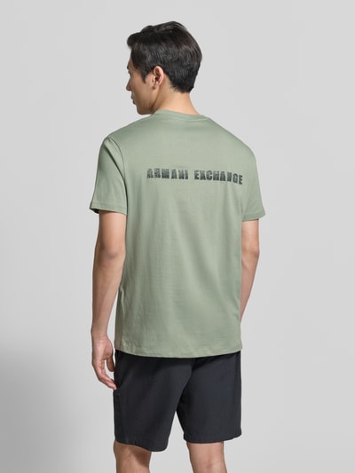 Männermodel trägt T-shirt met logo en ronde hals van ARMANI EXCHANGE, puur katoen, regular fit, ruglengte maat M 82 cm, Ganzkörperansicht Rückansicht.