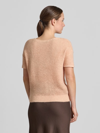 Frauenmodel trägt Strickpullover mit Alpaka-Anteil von Luisa Cerano, apricotfarben, Material-Mix, Ziernähte, gerippter Bund, ganzkörperansicht Rückansicht.