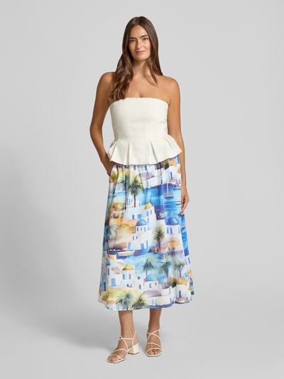 Vrouwenmodel draagt midirok uit viscosemix met all-over motiefprint van More & More, dames, A-lijn, sierstrik, bandwijdte maat 36: 36 cm, totale lengte maat 36: 85 cm, kleurenmix blauw wit geel groen, gladde stof, fullbody vooraanzicht.