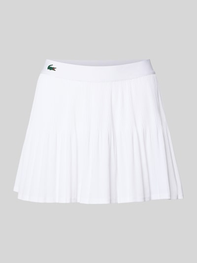 Produktfoto, Mini-Rock mit Plissee von Lacoste Sport in Weiß, unifarbene Optik, ausgestellte Passform, elastischer Bund, Logo-Patch, blickdichte Hose innen