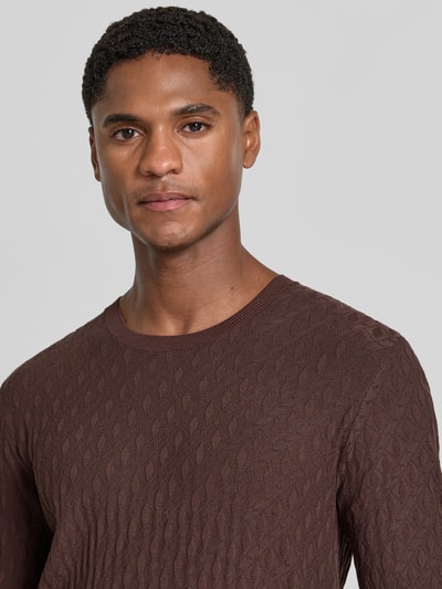 Männermodel trägt T-Shirt aus Viskose-Mix in Strick-Optik von Emporio Armani, braun, gerippte Abschlüsse, Nahaufnahme Oberkörper.
