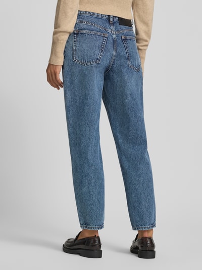 Frauenmodel trägt Mom Fit Jeans aus reiner Baumwolle im 5-Pocket-Design von HUGO in mittelblau mit strukturierter Oberfläche, Ganzkörperansicht Rückansicht. Damen Mom Fit Jeans von HUGO.