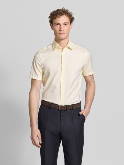 Männermodel trägt Regular Fit Business-Hemd mit Kentkragen von Christian Berg Men aus Reine Baumwolle, Kurzärmelig, Knopfleiste, Ganzkörperansicht von vorne.