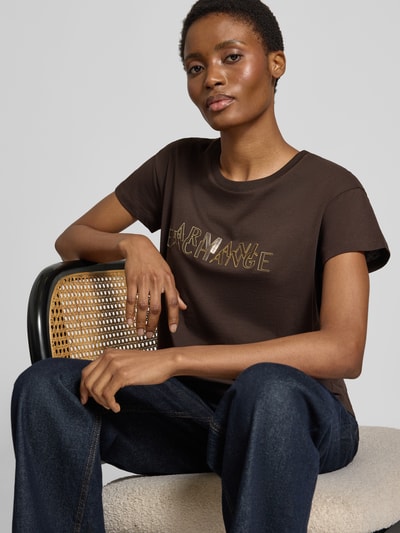 Kobiece model prezentuje Damski t-shirt Regular Fit T-Shirt aus reiner Baumwolle Model 'ANTAGONIST' von Armani Exchange z nadrukiem z logo, okrągły dekolt, kolor ciemnobrązowy, gładka faktura, Długość tyłu w rozmiarze S: 62 cm, półzbliżenie górnej części ciała.