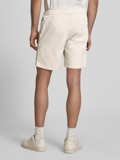 Männermodel trägt Shorts mit elastischem Bund Modell 'JAIDEN CARTER' von Jack & Jones aus Baumwoll-Elasthan-Mix, Strukturmuster, Regular-Fit, cremefarben, Rückansicht Ganzkörperansicht.