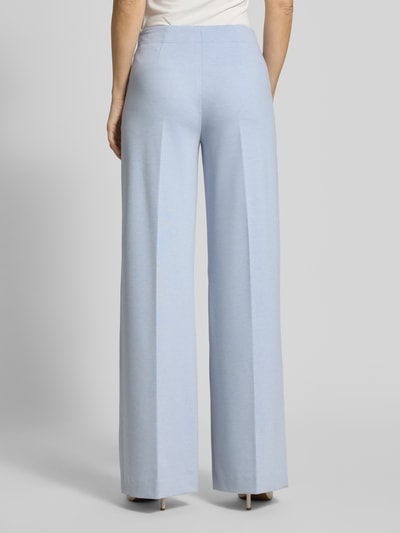 Vrouwenmodel draagt Hose mit weitem Bein und Bügelfalten Modell 'BEFORE' van Drykorn, lichtblauw, vloeiende stofstructuur, materiaal-mix met viscose, wijde pijp, geheelaanzicht achteraan.