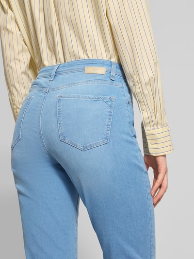 Frauenmodel trägt Flared Fit Jeans im 5-Pocket-Design Modell 'Carola' von Brax in Hellblau, elastischer Baumwoll-Mix, Detailaufnahme Rückansicht.