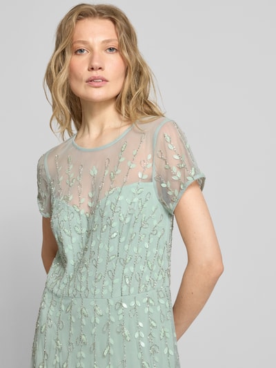 Modelka nosi Maxikleid mit Perlen und Pailletten von Adrianna Papell, miękka siateczka, A-linia, cekiny, perły, okrągły dekolt, długość pleców w rozmiarze 36: 152 cm, szerokość w rozmiarze 36: 35 cm, pastelowa zieleń, detale jasnozielone, tekstura błyszcząca, zbliżenie na górną część ciała