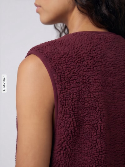 Frauenmodel trägt Regular Fit Weste in Teddyfell-Optik Modell 'BABY' von ONLY in Dunkelrot, grobe Struktur, Nahaufnahme Schulter, Damen Weste von ONLY, KI-modifiziertes Bild.
