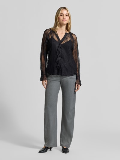Modelka nosi Langarmbluse mit semitransparentem Spitzeneinsatz von S. OLIVER BLACK LABEL, czarny, koronka, V-neck, koronkowe, falbany, długie rękawy, optyka koronki, widok całej sylwetki z przodu.