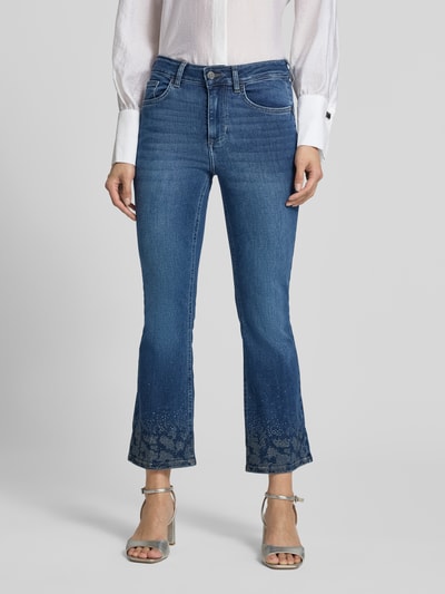 Frauenmodel trägt Flared Fit Jeans aus mieszanka bawełny i lyocellu z obszyciem kamieni stras, 5 kieszeni, zapięcie na guzik i zamek błyskawiczny, Model 'Princess' od Liu Jo White, Długość wewnętrzna nogawki 67 cm, Szerokość w rozmiarze 27: 36 cm, skrócony krój, Ganzkörperansicht von vorne