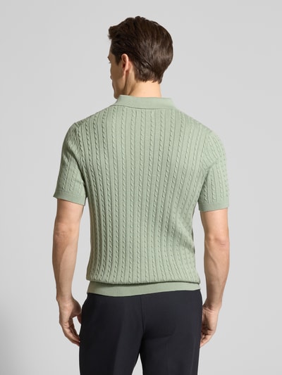 Männermodel trägt Slim Fit Poloshirt in Strick-Optik von Christian Berg Men in Mintgrün, feine Struktur, Kurzarm, Ganzkörperansicht Rückansicht.