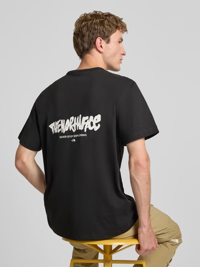 Männermodel trägt Relaxed Fit T-Shirt aus reiner Baumwolle mit Logo-Print von The North Face in Schwarz, Rundhalsausschnitt, Rückansicht, Ganzkörperansicht Rückansicht.