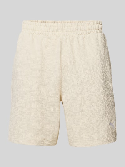 Produktfoto, Shorts mit Logo-Stitching von PUMA PERFORMANCE aus Reine Baumwolle in Beige mit Strukturmuster, Gerader-Schnitt, Elastischer Bund.