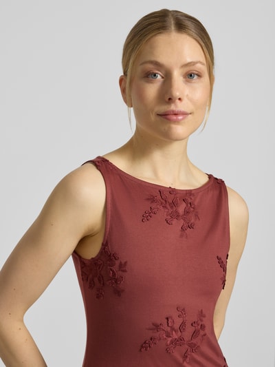 Modelka kobieca nosi Regular Fit Top mit Baumwoll-Anteil Modell 'VIVIAN' od Vero Moda, kolor jednolity bordowy, hafty, jersey, krój regular fit, u-łódkowy dekolt, bez rękawów, widok na górną część ciała z przodu.