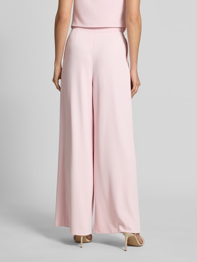 Frauenmodel trägt Stoffhose mit französischen Eingrifftaschen von Rinascimento, rosa, Wide Leg Fit, Stretch, glatte Textur, Ganzkörperansicht Rückansicht.